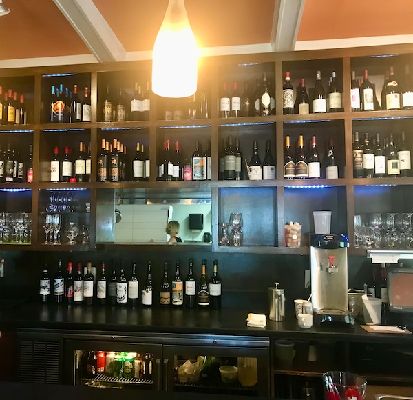 A bar with shelves and shelves of wine bottles at Vin 909 in Annapolis Maryland