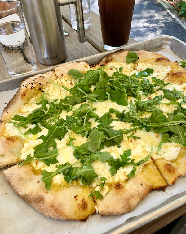 An oval pizza topped with cheese and herbs at Vin 909 in Annapolis Maryland