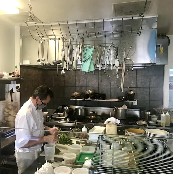 A chef prepping food in a commercial kitchen at Vin 909 in Annapolis Maryland