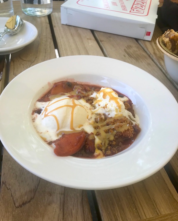 A white bowl filled with red fruit and white ice cream at Vin 909 in Annapolis Maryland