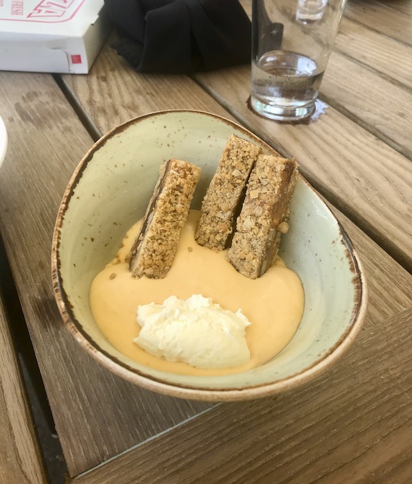 A tan bowl filled with tan pudding, cookies and whipped cream at Vin 909 in Annapolis Maryland