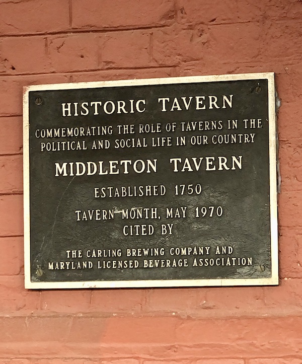 An historic marker on a tan brick building in Washington DC and Annapolis Maryland