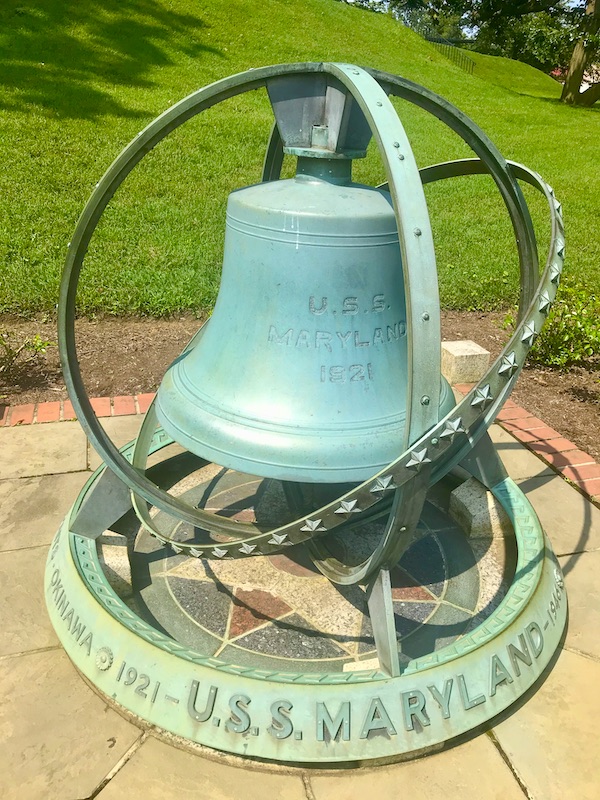 A small verdigris bell commemorating the USS Maryland in Washington DC and Annapolis Maryland