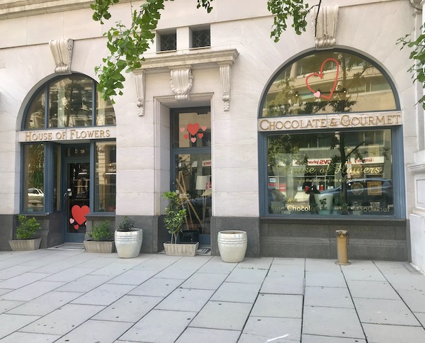A white storefront with arched windows that is the House of Flowers in Washington DC and Annapolis Maryland