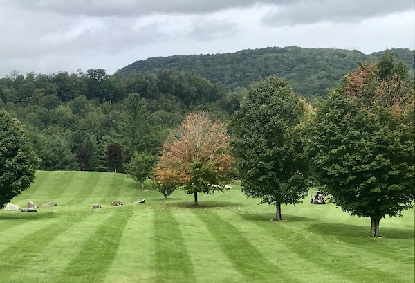A golf course lawn with trees and mountains near the Blue Ridge Parkway NC