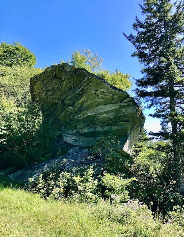 A fan shaped rock with trees and blue sky along the Blue Ridge Parkway NC