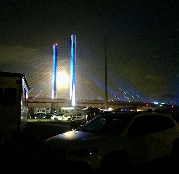 A full moon lighting the bridge and campgrounds at Delaware Seashore State Park