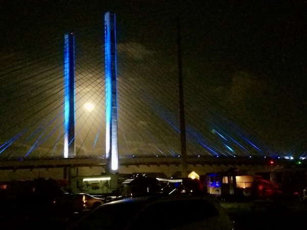 A full moon right between two pillars of the bridge at Delaware Seashore State Park