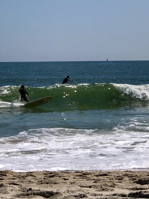 Ocean with surfers at Delaware Seashore State Park