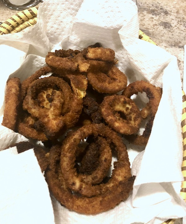 A paper towel lined basket filled with fried onion rings at Delaware Seashore State Park