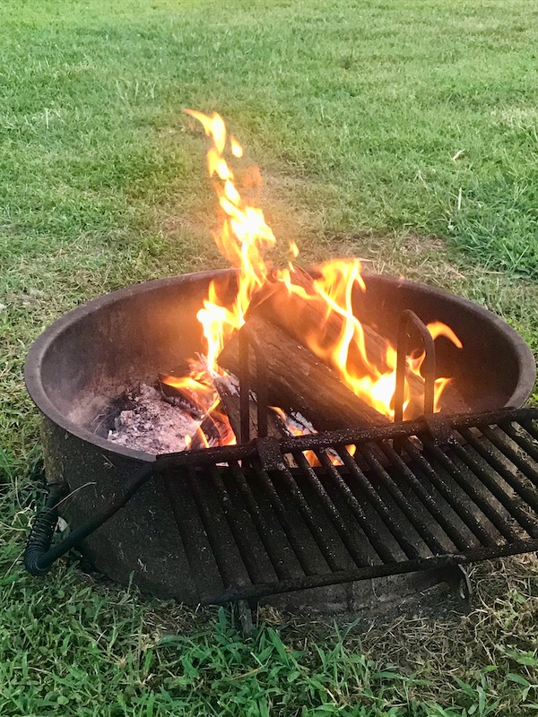 A bonfire in a fire ring on the lawn at Kiptopeke State Park in Virginia