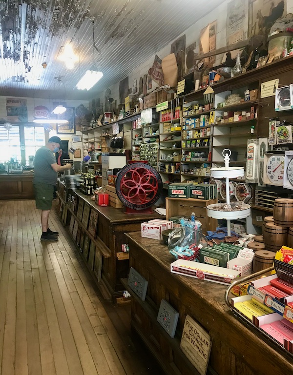 A man trying to decide on a purchase at a general store at Mast General Store