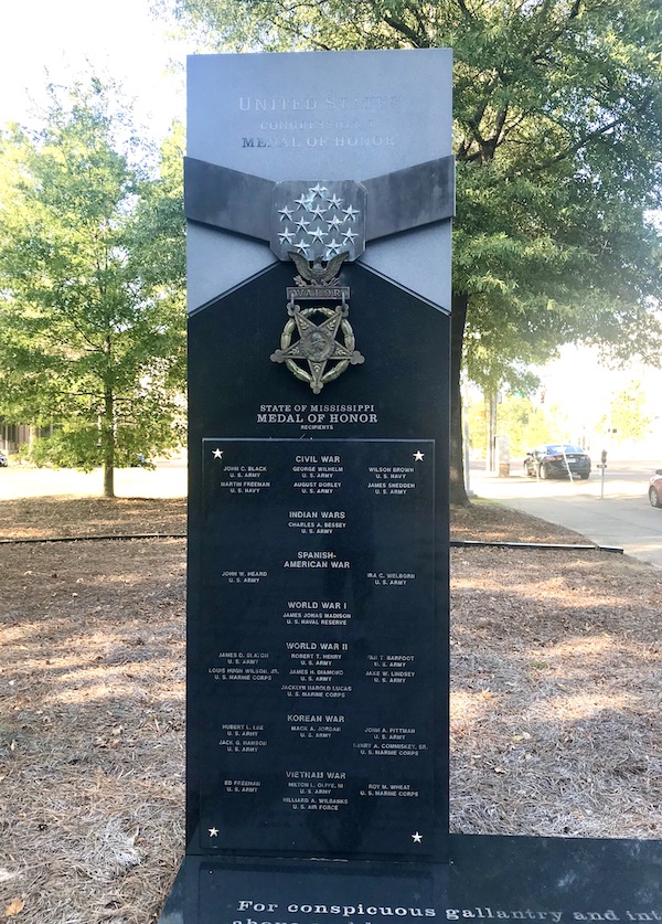 A black gray and gold monument to medal of honor recipients in Jackson Mississippi