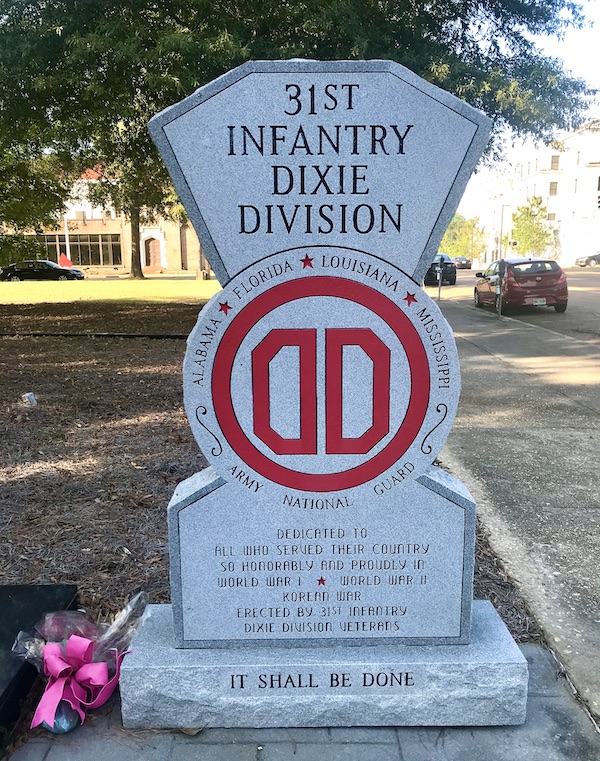 A gray WW I monument with red letters in Jackson Mississippi