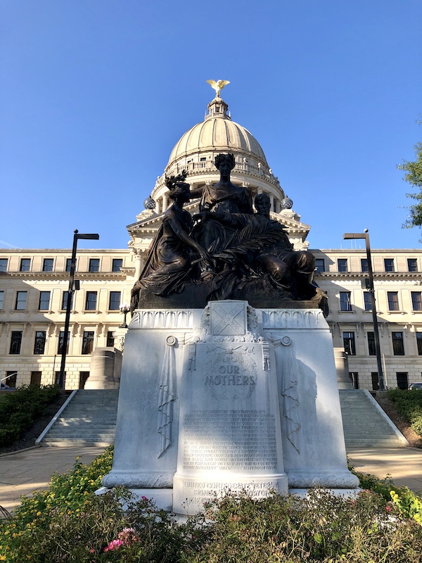 A large monument topped with 3 bronze figures in Jackson Mississippi