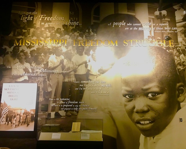A mural of photos and quotes at the Mississippi Civil Rights Museum