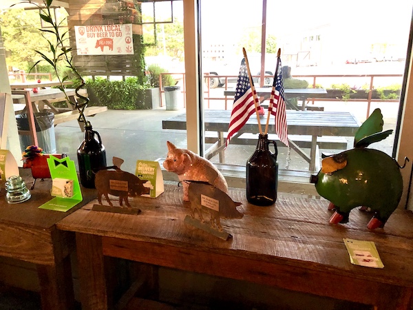 A window sill with various pig knick knacks displayed near Mississippi Civil Rights Museum