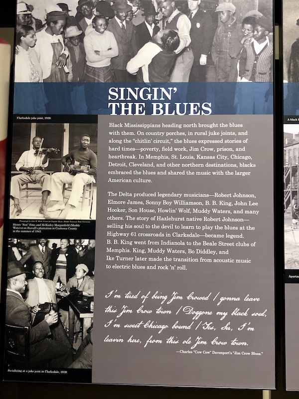 A sign with photos of musicians explaining the birth of the Blues at the Mississippi Civil Rights Museum
