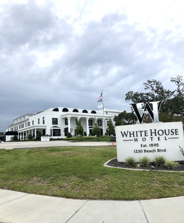 A sign and partial view if a white hotel along our drive from NOLA to Biloxi