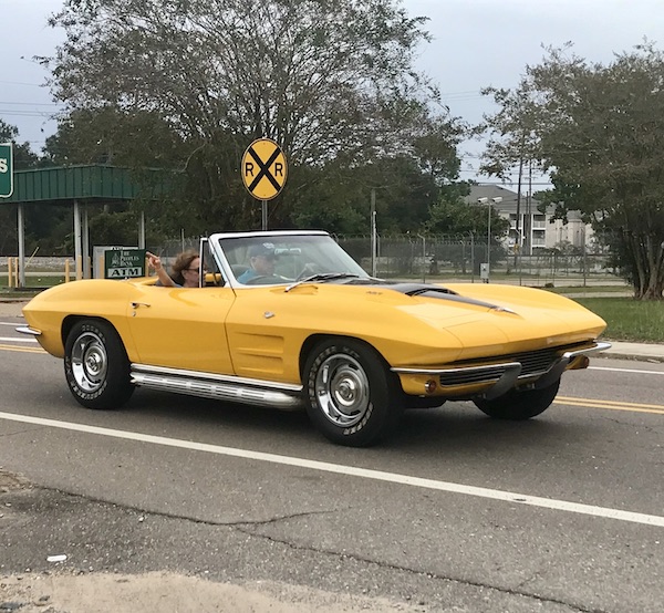 A bright yellow sports car with the top down along our drive from NOLA to Biloxi