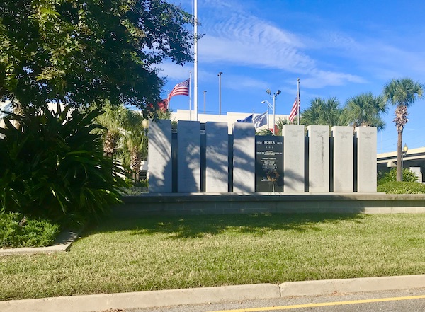 A white building with lawn and trees, the Korean War Memorial on our drive from NOLA to Biloxi