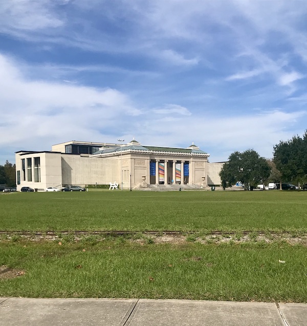 A large white building on a sprawling lawn at New Orleans City Park