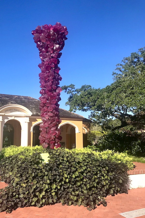 A garden entry with a purple glass column at New Orleans City Park