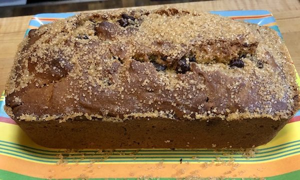 Yellow, blue and orange striped plate topped with a Pumpkin Chocolate Chip Loaf