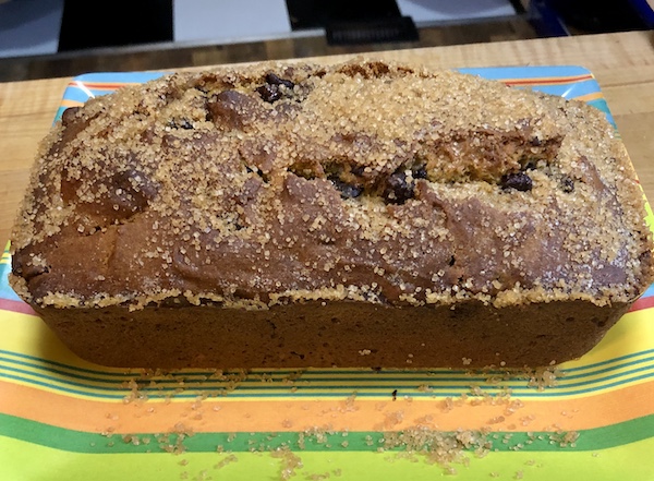 Yellow, blue and orange striped plate topped with a Pumpkin Chocolate Chip Loaf