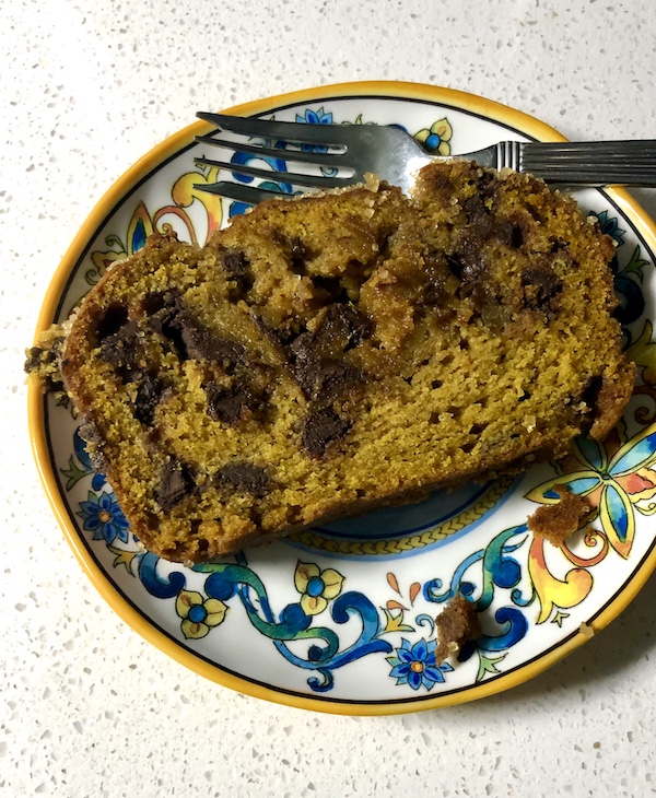 A dessert plate topped with a slice of Pumpkin Chocolate Chip Loaf