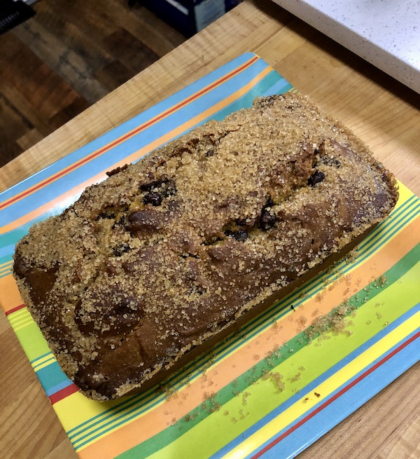 A square colored striped plate topped with a Pumpkin Chocolate Chip Loaf