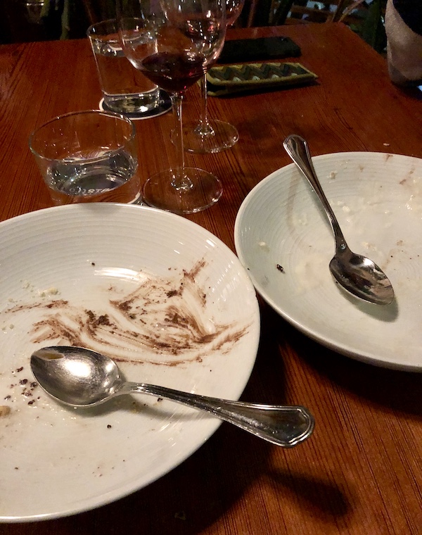 Two white plates with dessert spoons resting on them and traces of chocolate at Revisiting Bywater American Bistro