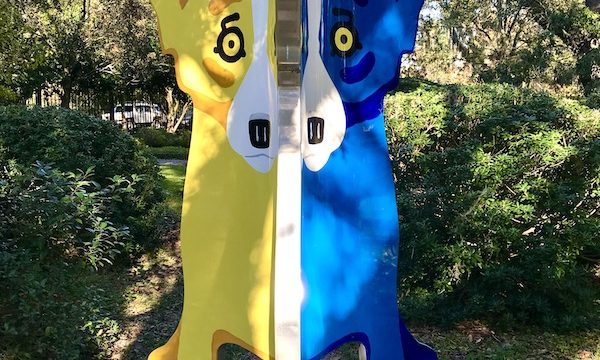 A sculpture of a blue dog and yellow dog at Bestoff Sculpture Garden