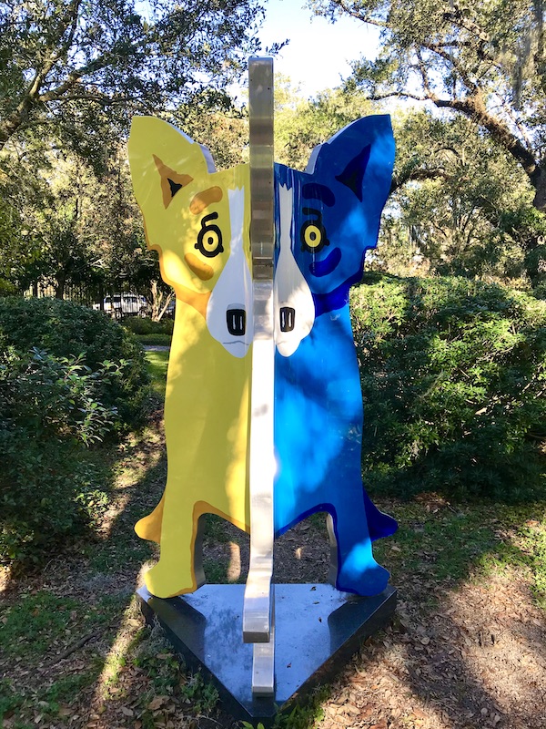 A sculpture of a blue dog and yellow dog at Bestoff Sculpture Garden