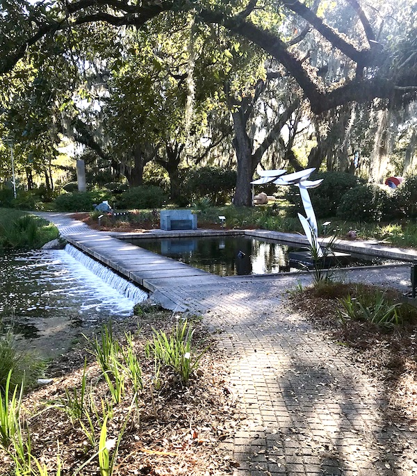 A sculpture of birds by a waterfall at the Bestoff Sculpture Garden