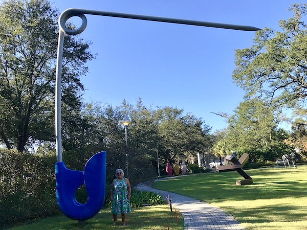 A huge safety pin sculpture with blue head at the Bestoff Sculpture Garden