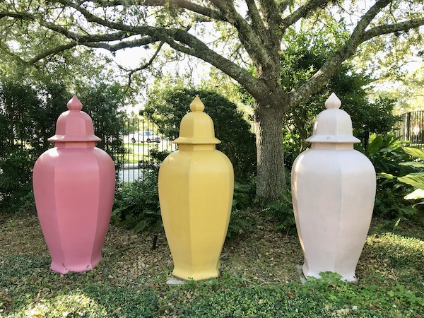 Three urns, one pink, one yellow and one white at the Bestoff Sculpture Garden