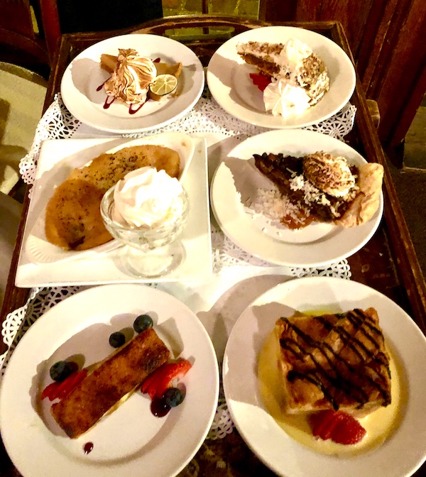 A dessert cart topped with 6 different dessert options at Café Vermillionville Lafayette Louisiana