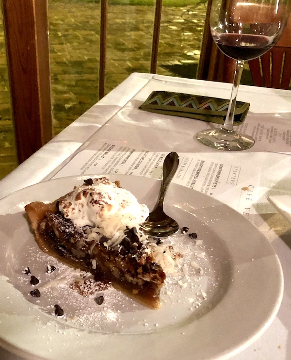 A slice of nutty brown pie on a white plate with a fork at Café Vermillionville Lafayette Louisiana