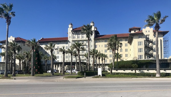 A huge white hotel with barrel tile roof on Galveston Island Texas