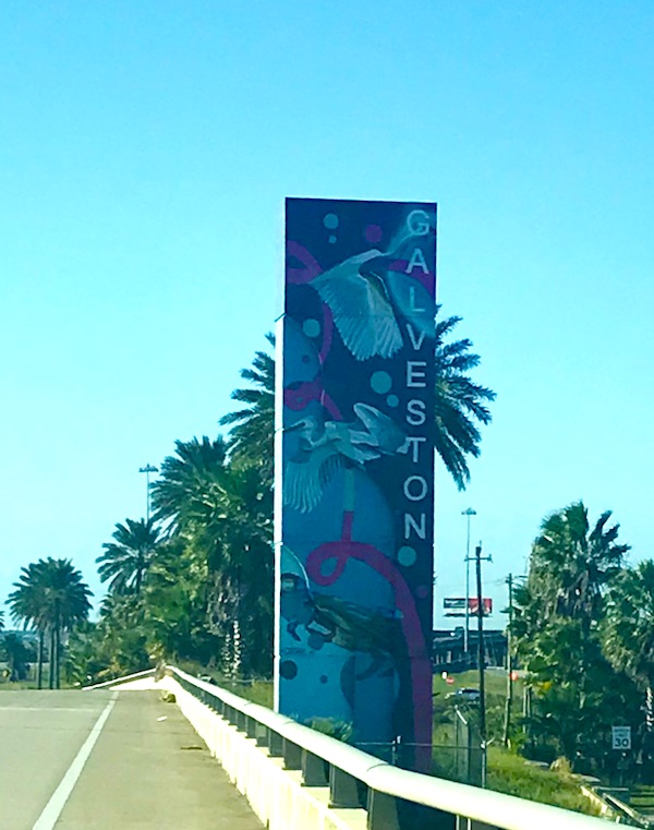 A pilar that's colorfully painted and reads Galveston on Galveston Island Texas
