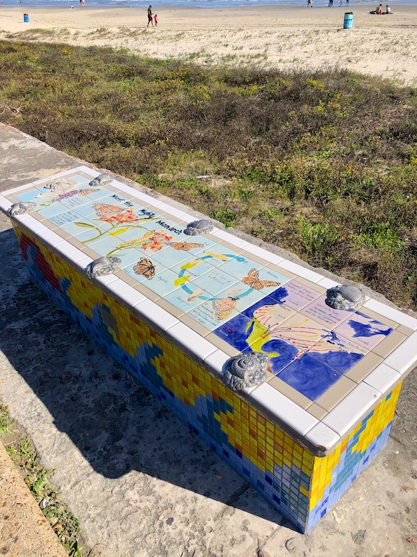 A colorful mosaic bench by the beach on Galveston Island Texas