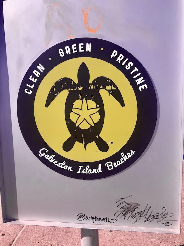 A save the turtles sign by the beach on Galveston Island Texas