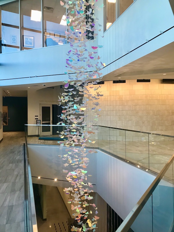 Hundreds of irridescent butterflies handing from the ceiling at the Holocaust Museum Houston