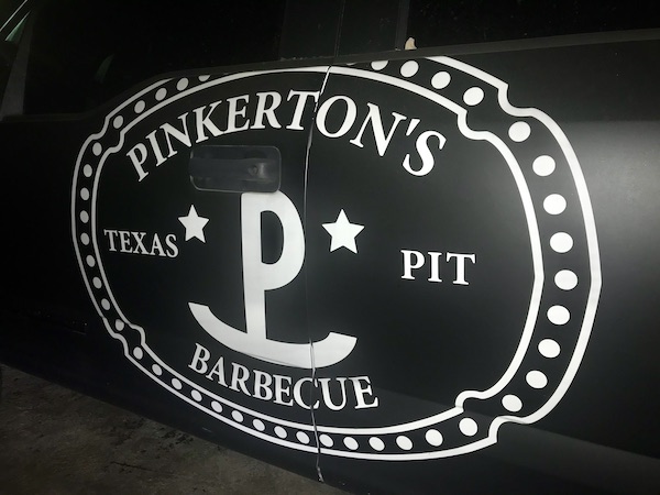 A black and white sign for a BBQ Restaurant near the Holocaust Museum Houston