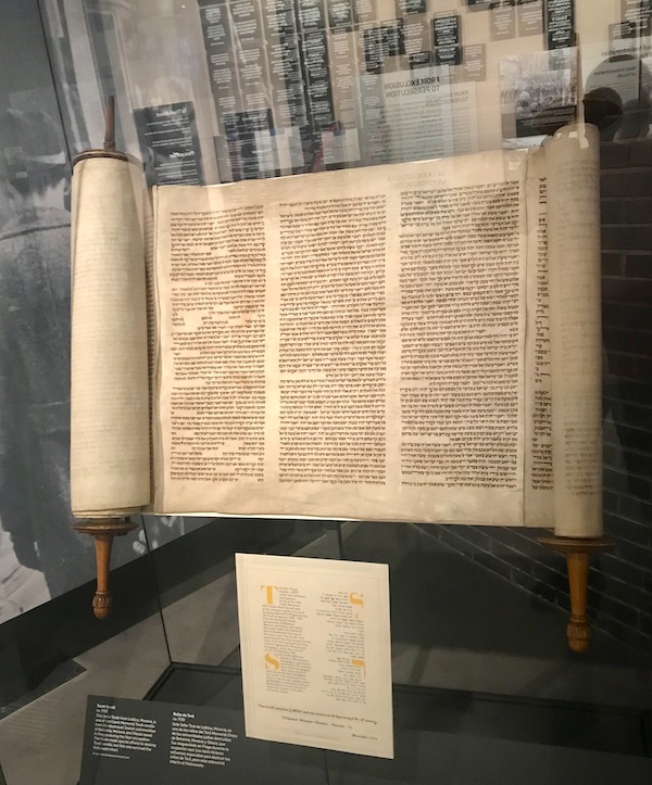 A torah scroll in a glass case at the Holocaust Museum Houston