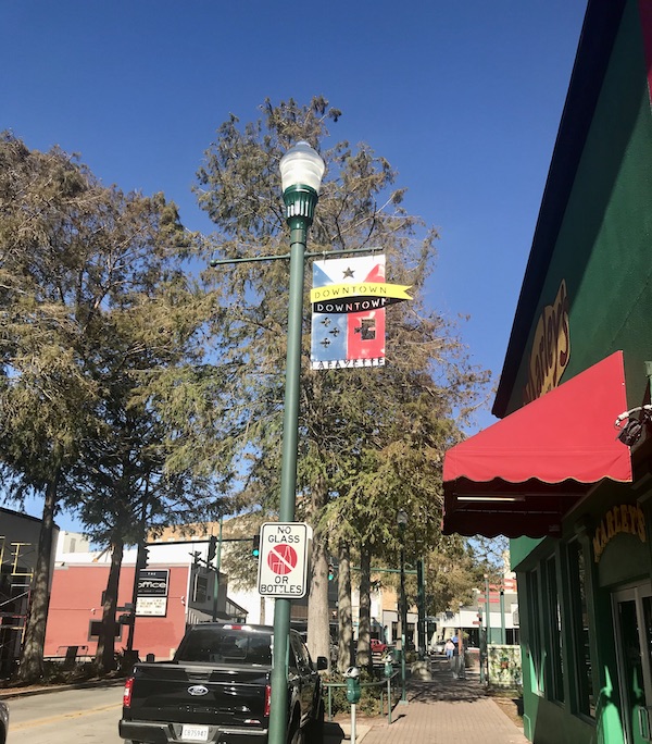 A street with shops and red awning in Southwestern Louisiana