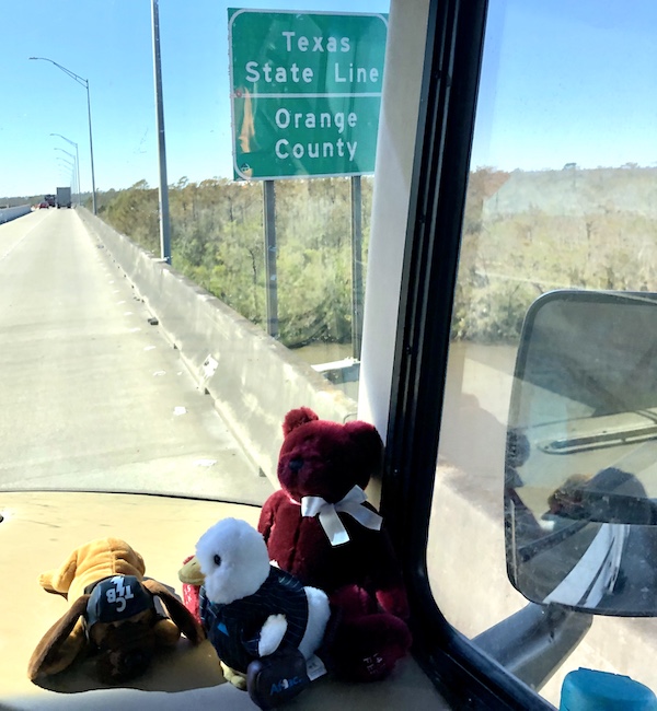 Highway sign welcoming us to Texas seen through the RV windshield from Texas at Last!