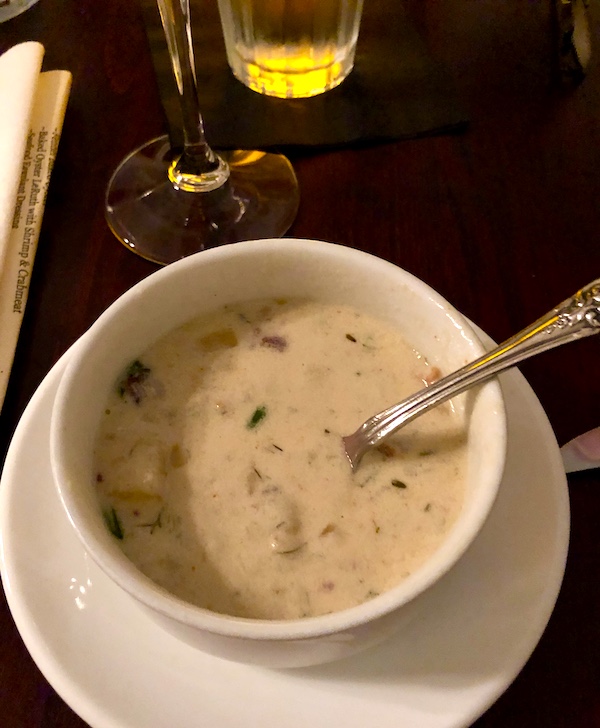 Tidbits of Life in New Orleans a beige bowl of creamy soup on a plate with a spoon in the bowl.