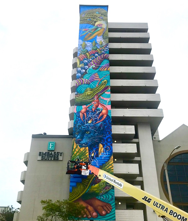 Tidbits of Life in New Orleans A building with a colorful mural being painted.